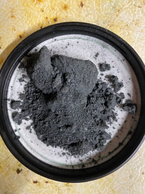 A bowl of powdered charcoal on the counter.