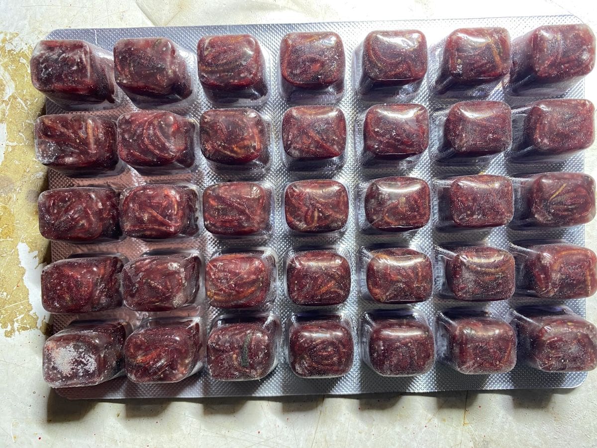 A tray of chocolate covered marshmallows sitting on top of a table.