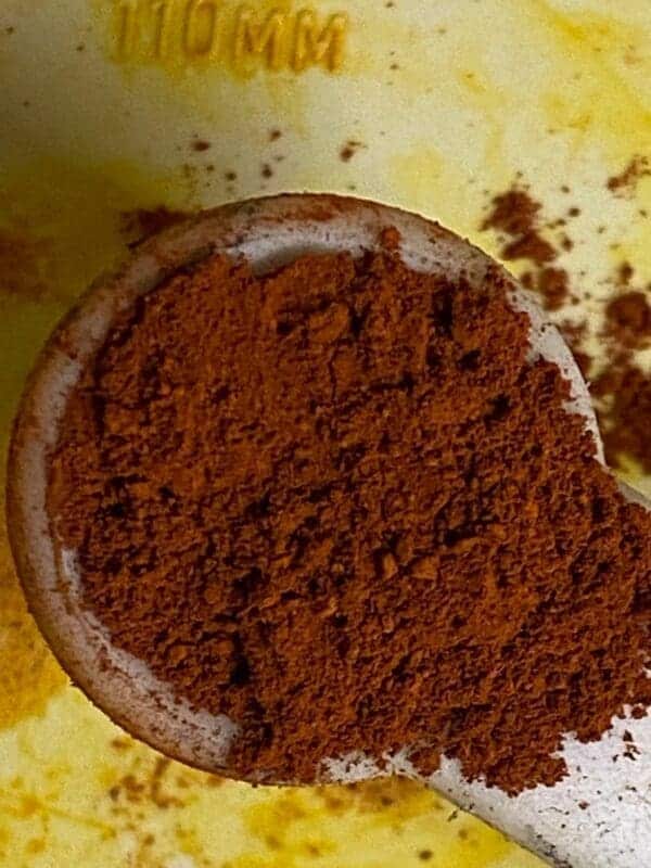 A bowl of ground coffee on top of a table.